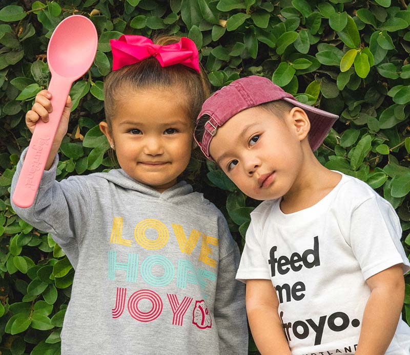 Two children wearing Yogurtland branded apparel